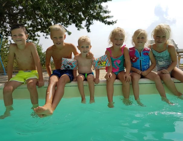 children-sitting-swimming-pool
